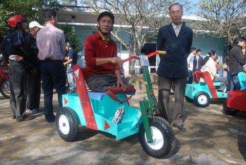 Disabled Vietnamese man with his new P.E.T. mobility chair